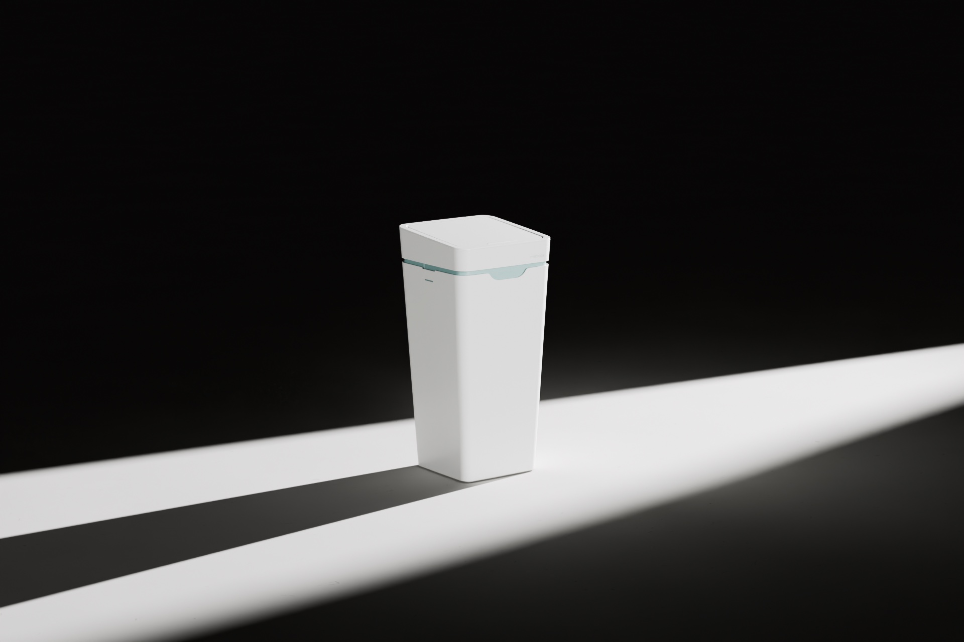 A white Mono bin with its lid closed, in a beam of light