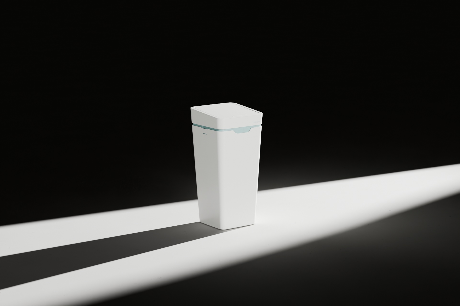 A white Mono bin with its lid closed, in a beam of light